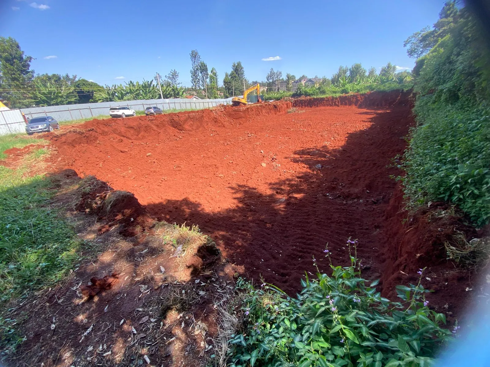 The excavated basin of the Opal Suites site, machine at the far wall