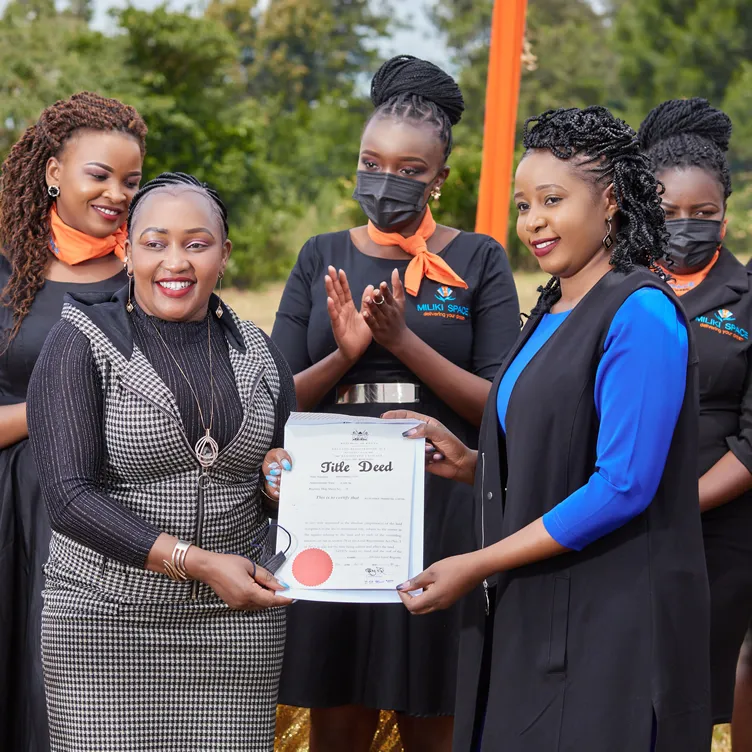 A certificate handed over, applause all round